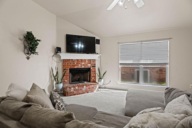 living room featuring ceiling fan, lofted ceiling, a fireplace, and carpet floors