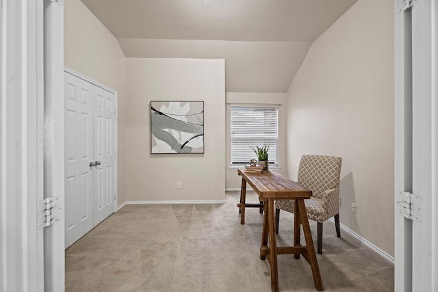 office space with light colored carpet and vaulted ceiling