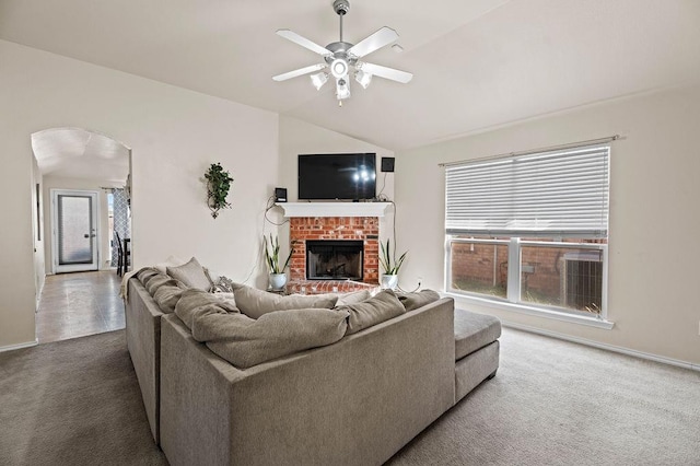 carpeted living room featuring lofted ceiling, a fireplace, and ceiling fan