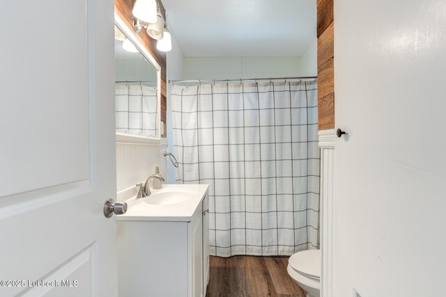 5320 25th St, Lubbock, TX 79407 - bathroom featuring vanity, toilet, wood finished floors, and a shower with curtain