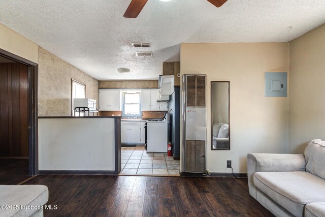 5320 25th St, Lubbock, TX 79407 - kitchen with white gas range, electric panel, ceiling fan, a sink, and open floor plan