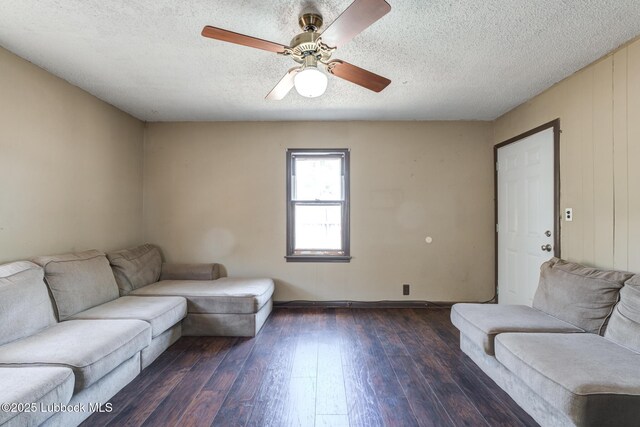 5320 25th St, Lubbock, TX 79407 - living area featuring dark wood-style flooring, a ceiling fan, baseboards, and a textured ceiling