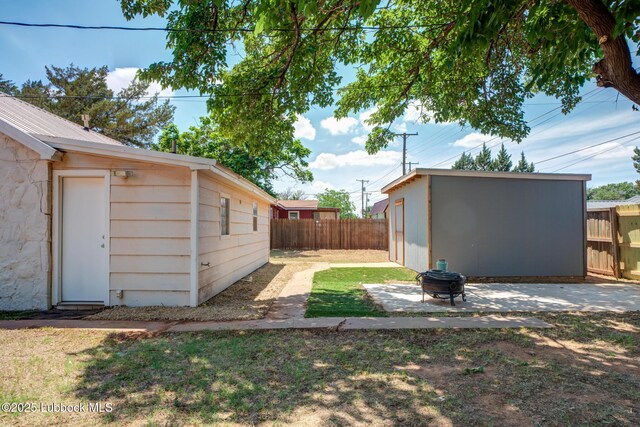 5320 25th St, Lubbock, TX 79407 - view of yard with an outdoor fire pit, an outdoor structure, and a patio