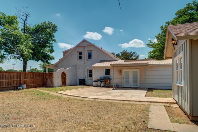 5320 25th St, Lubbock, TX 79407 - back of property with central air condition unit, french doors, a patio, and metal roof
