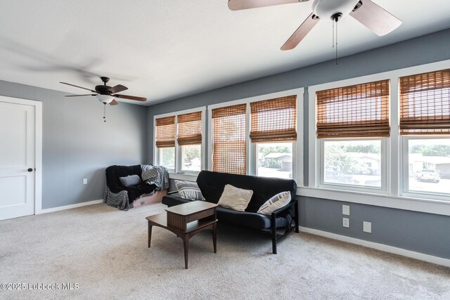 5320 25th St, Lubbock, TX 79407 - living room with ceiling fan, light carpet, and baseboards