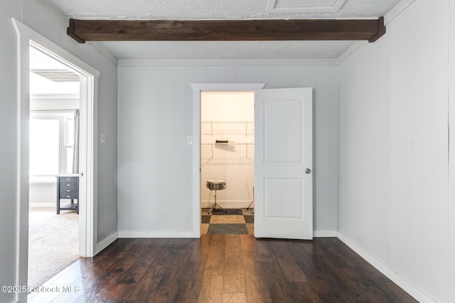 5320 25th St, Lubbock, TX 79407 - empty room with beamed ceiling, dark wood-style flooring, and baseboards