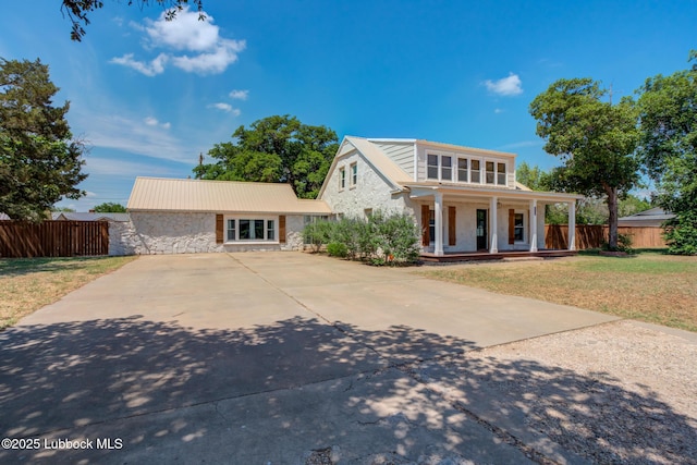 5320 25th St, Lubbock, TX 79407 - view of front of home featuring stone siding, covered porch, and concrete driveway