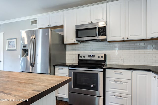 5320 25th St, Lubbock, TX 79407 - kitchen featuring stainless steel appliances, white cabinetry, tasteful backsplash, ornamental molding, and wood counters