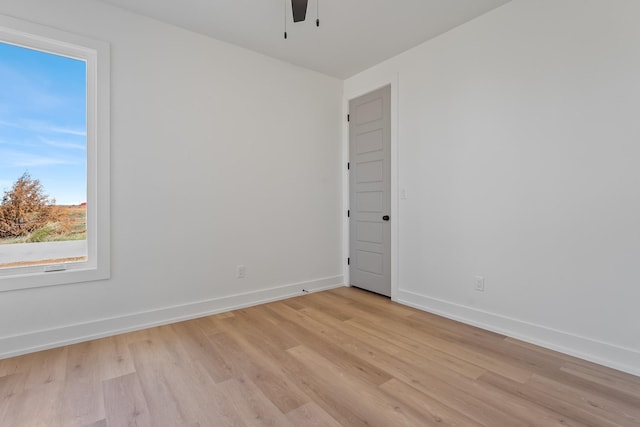 empty room with ceiling fan and light wood-type flooring