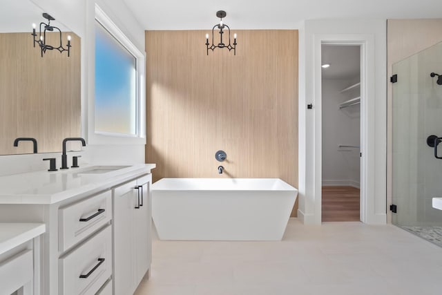 bathroom with vanity, tile patterned flooring, a chandelier, and separate shower and tub