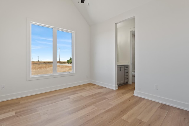 unfurnished room with lofted ceiling, light hardwood / wood-style floors, and ceiling fan