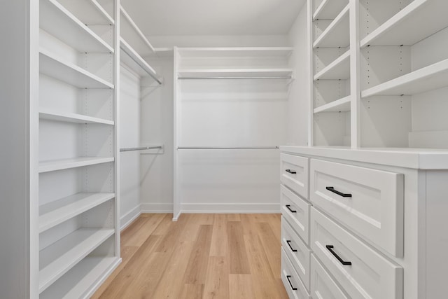 walk in closet featuring light hardwood / wood-style flooring