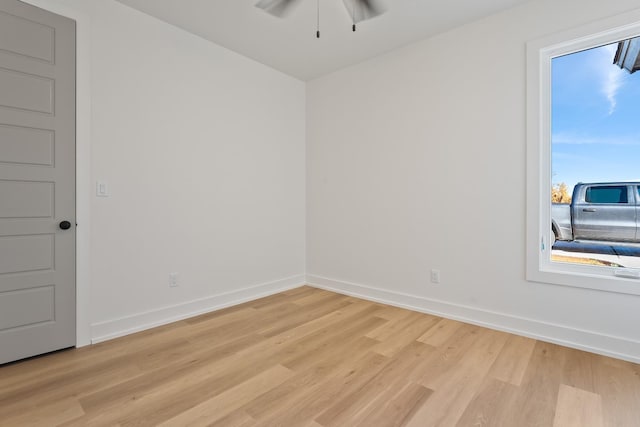 empty room with ceiling fan and light wood-type flooring