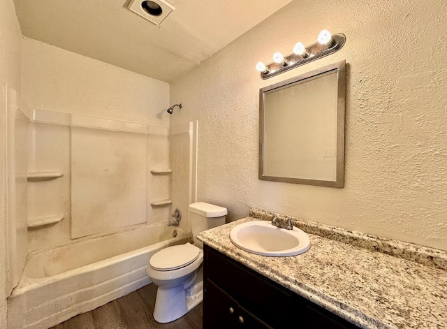 full bathroom with hardwood / wood-style flooring, vanity, toilet, and shower / tub combination