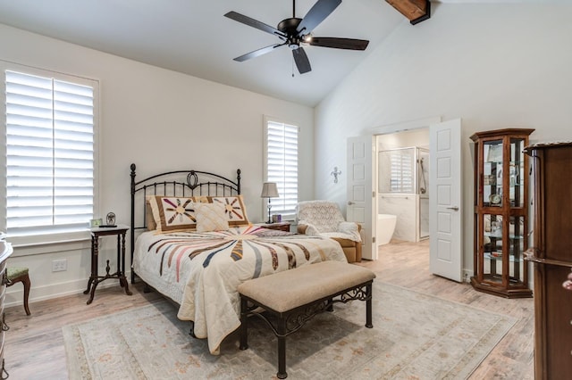 bedroom with ceiling fan, beam ceiling, high vaulted ceiling, ensuite bathroom, and light wood-type flooring