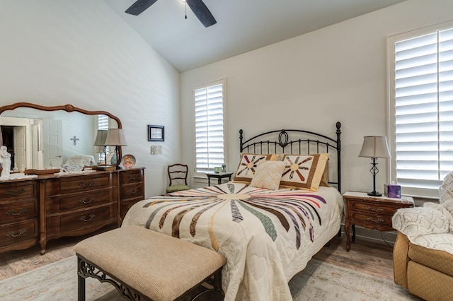 bedroom with ceiling fan, lofted ceiling, and light hardwood / wood-style flooring