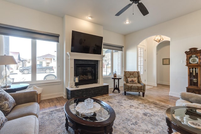 living room featuring ceiling fan and light wood-type flooring