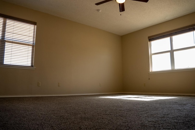 carpeted empty room with a textured ceiling and ceiling fan