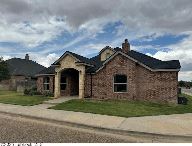 1406 N 14th St, Wolfforth, TX 79382 - french provincial home featuring brick siding, fence, a chimney, and a front yard