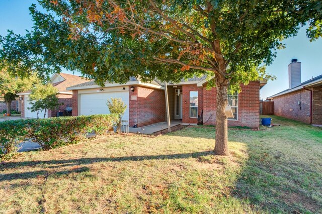 view of front of home with a garage and a front yard