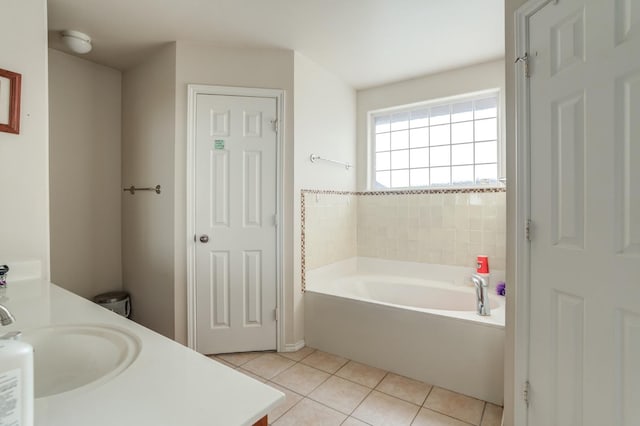 bathroom featuring tile patterned flooring, vanity, and a tub to relax in