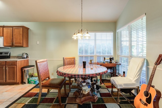 tiled dining area with a chandelier