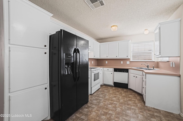 1712 75th St, Lubbock, TX 79423 - kitchen with white appliances, a sink, white cabinetry, light countertops, and a textured ceiling