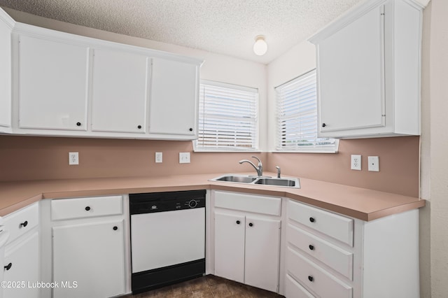 1712 75th St, Lubbock, TX 79423 - kitchen featuring white dishwasher, a sink, light countertops, white cabinets, and a textured ceiling