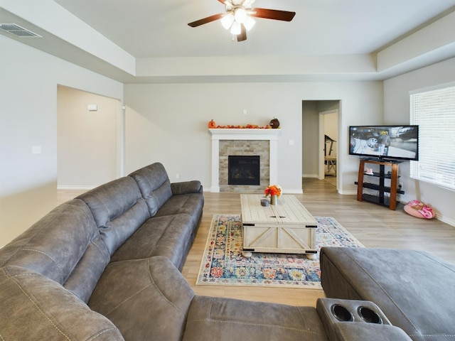 living room featuring wood-type flooring and ceiling fan