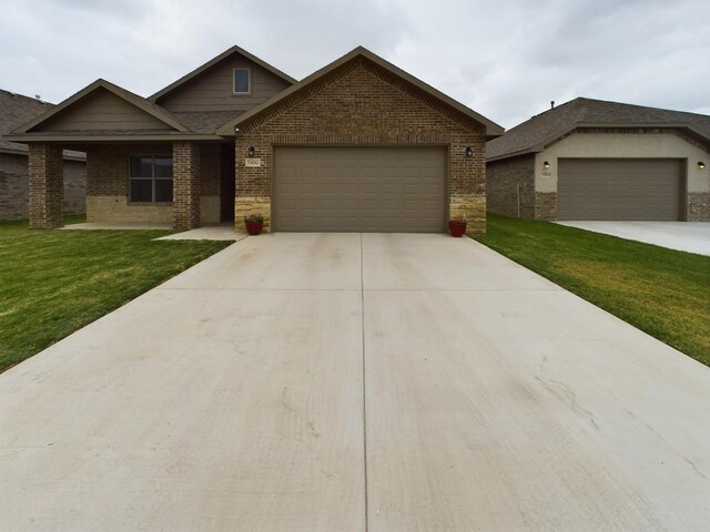 view of front of home featuring a garage and a front lawn