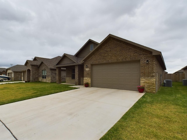 view of front of property with cooling unit, a garage, and a front lawn