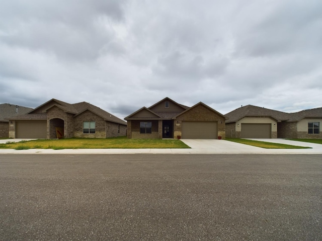 view of front of home with a garage and a front lawn