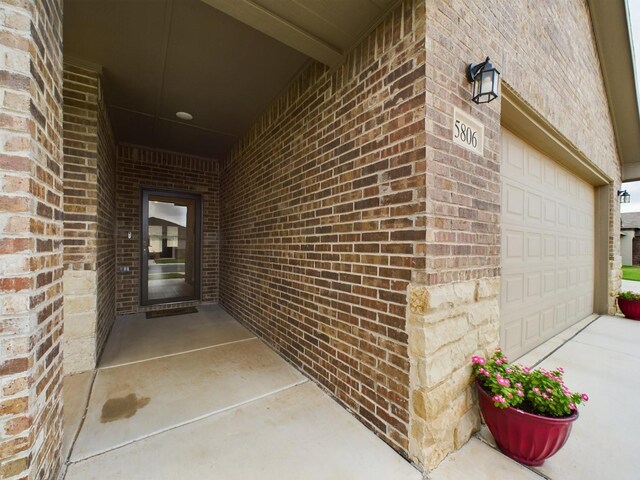 doorway to property with a garage