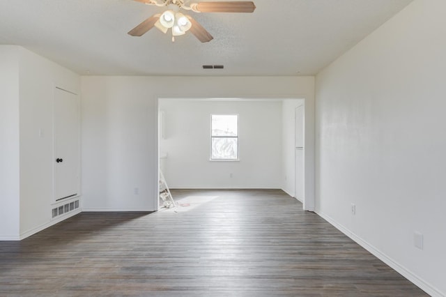 spare room with dark wood-type flooring, ceiling fan, and a textured ceiling