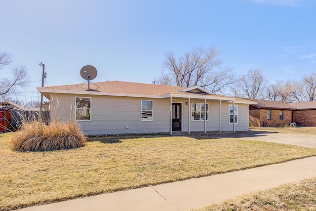 single story home featuring concrete driveway and a front yard