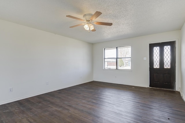 entrance foyer featuring a ceiling fan, baseboards, dark wood finished floors, and a textured ceiling