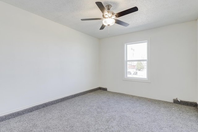 spare room featuring a textured ceiling, ceiling fan, and carpet flooring