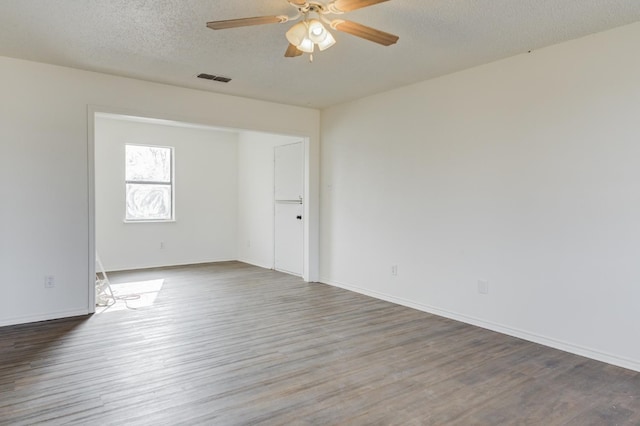 empty room with wood-type flooring, ceiling fan, and a textured ceiling