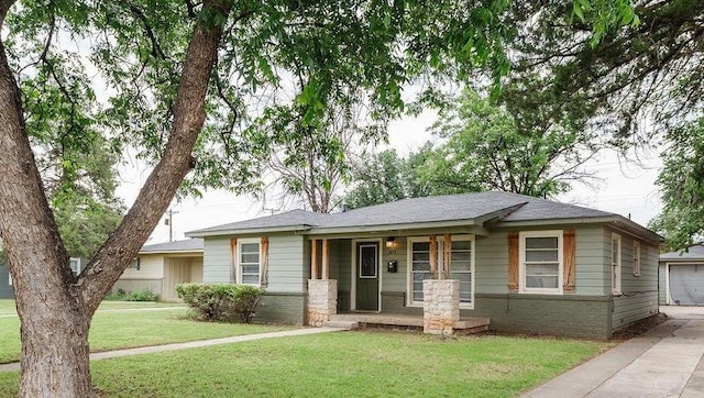 view of front of house featuring a garage, covered porch, and a front lawn