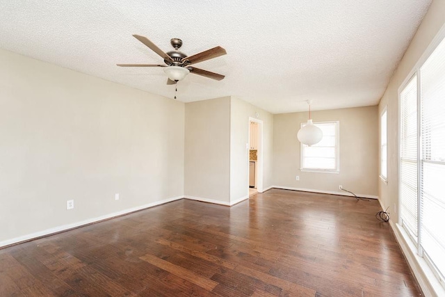 unfurnished room featuring dark wood-type flooring, ceiling fan, and a textured ceiling