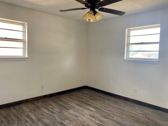 unfurnished room featuring dark hardwood / wood-style flooring, ceiling fan, and a textured ceiling