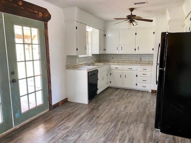 kitchen with dark hardwood / wood-style floors, tasteful backsplash, sink, white cabinets, and black appliances