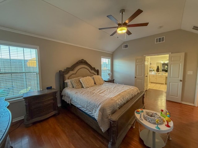 bedroom with vaulted ceiling, ornamental molding, dark hardwood / wood-style floors, and ceiling fan