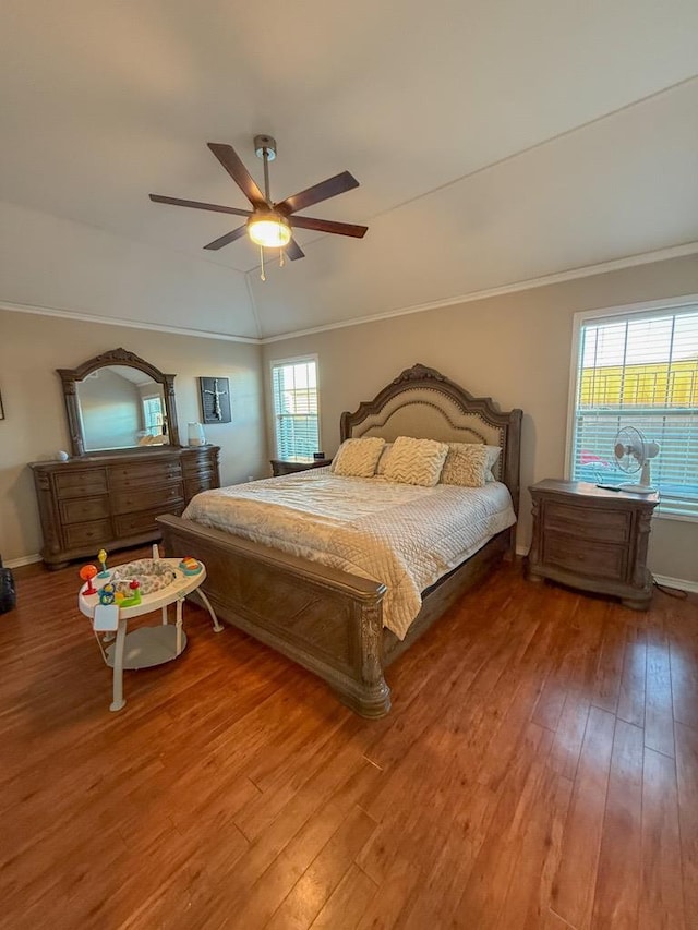 bedroom with multiple windows, hardwood / wood-style flooring, and ornamental molding