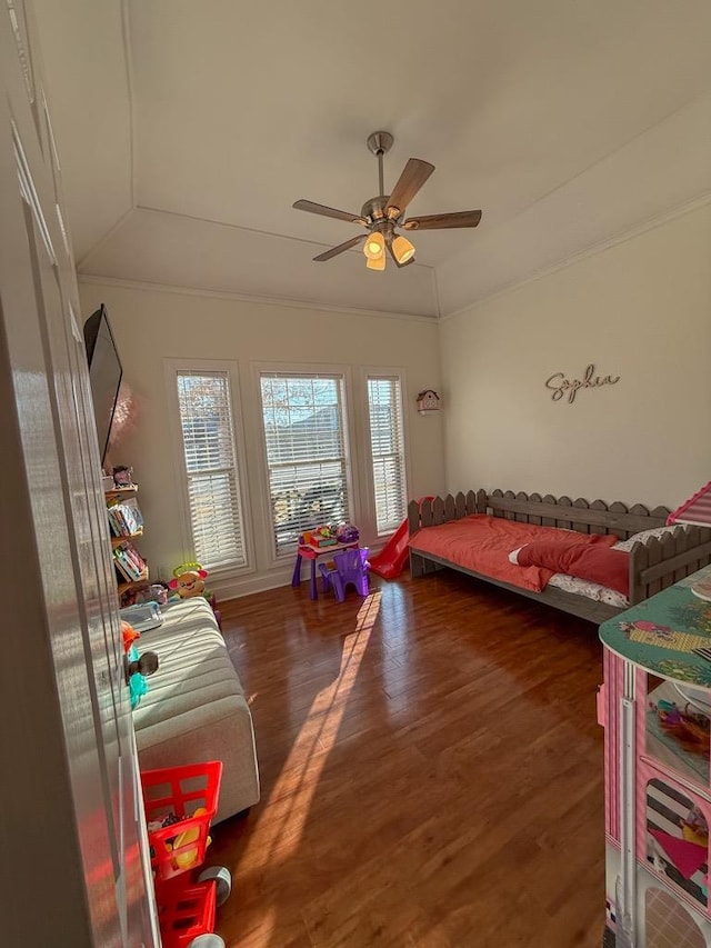 bedroom featuring ornamental molding, lofted ceiling, dark wood-type flooring, and ceiling fan