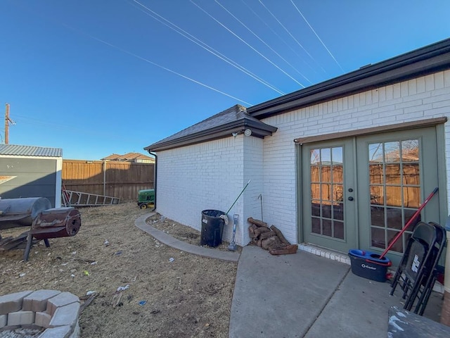 view of property exterior with a patio area and french doors