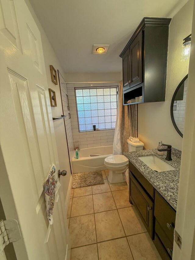 full bathroom with tile patterned flooring, vanity, shower / bathtub combination with curtain, and toilet