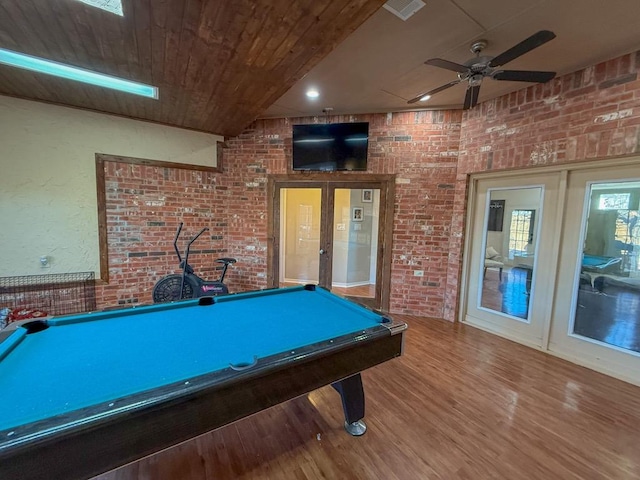 recreation room featuring wood-type flooring, brick wall, wood ceiling, and french doors