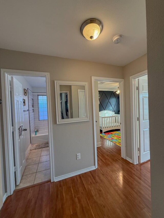 corridor with light hardwood / wood-style flooring