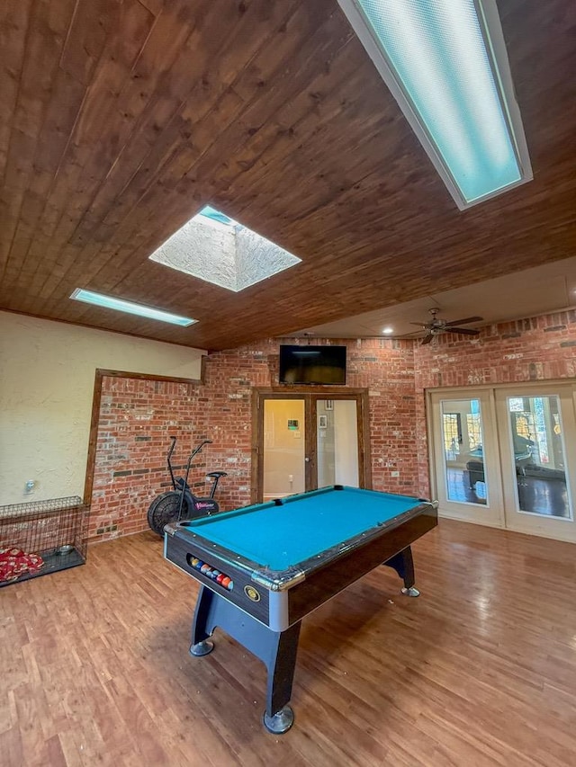 game room featuring wood-type flooring, brick wall, wood ceiling, and french doors